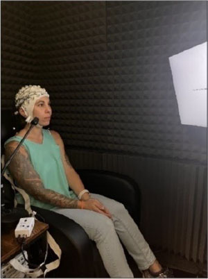 Young subject listening to a sentence while EEG responses are recorded.